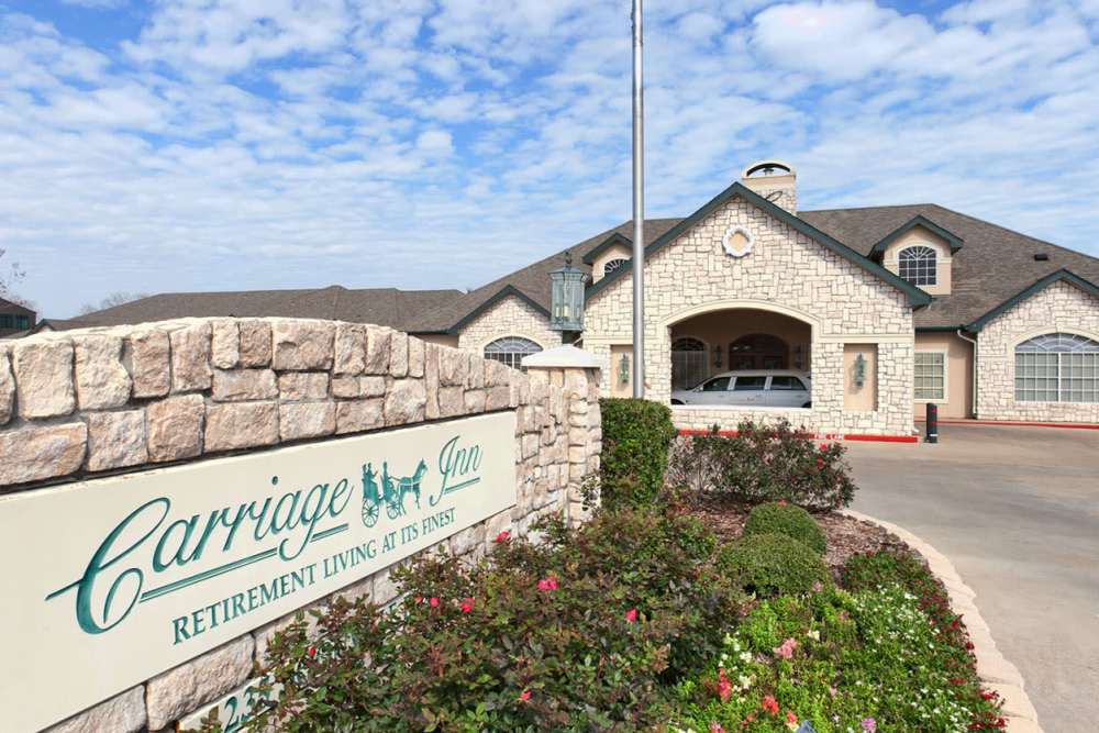 Branding and signage in front of Carriage Inn Bryan in Bryan, Texas
