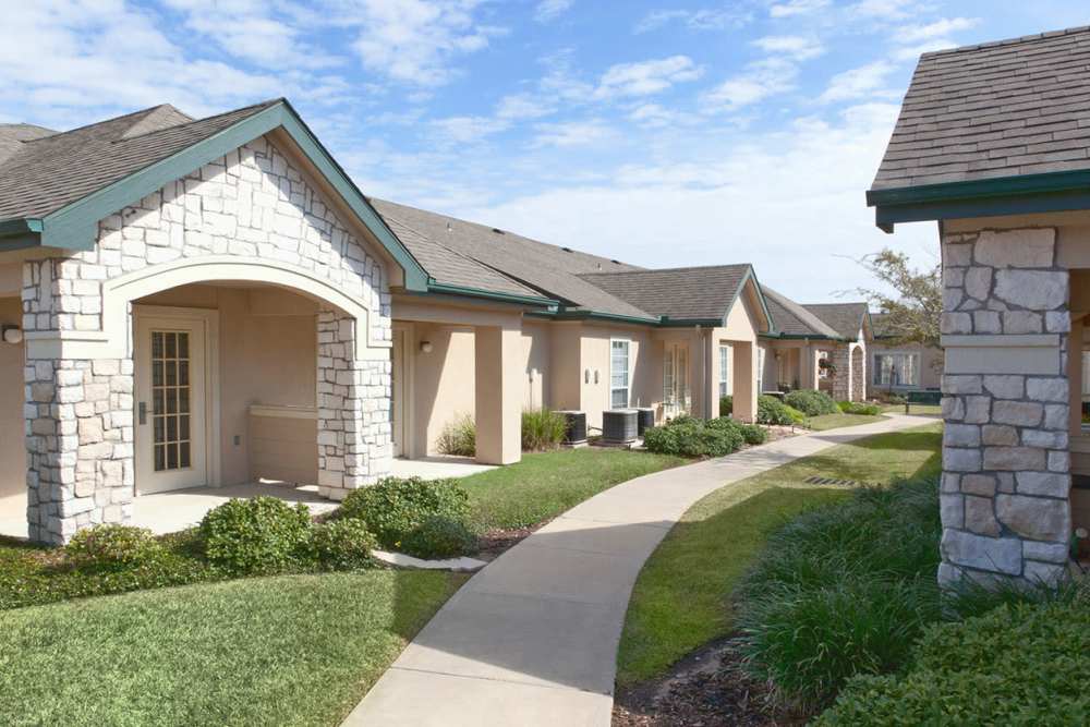 A walkway between homes at Carriage Inn Bryan in Bryan, Texas