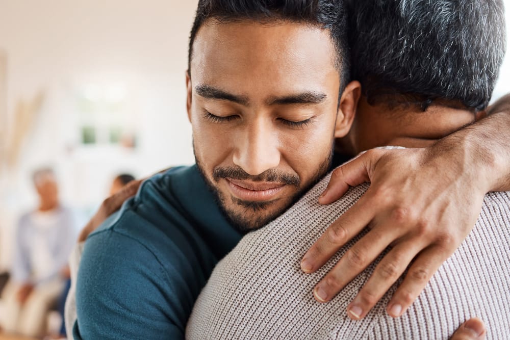 Resident and a younger family member hugging at Regency on Whidbey in Oak Harbor, Washington