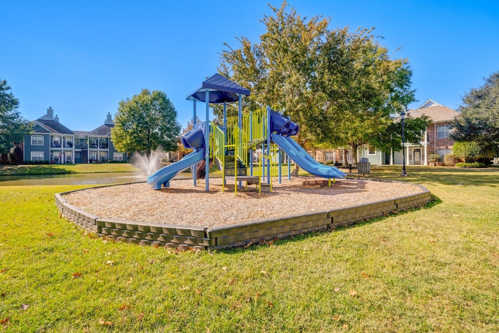 Exterior playground view at Audubon Lake Apartments in Lafayette, LA