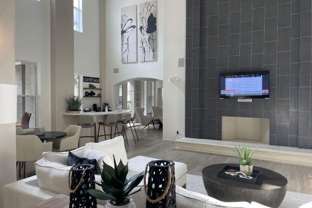 Resident seating area with large chairs and flat-screen TV at Heights on Katy in Houston, Texas,