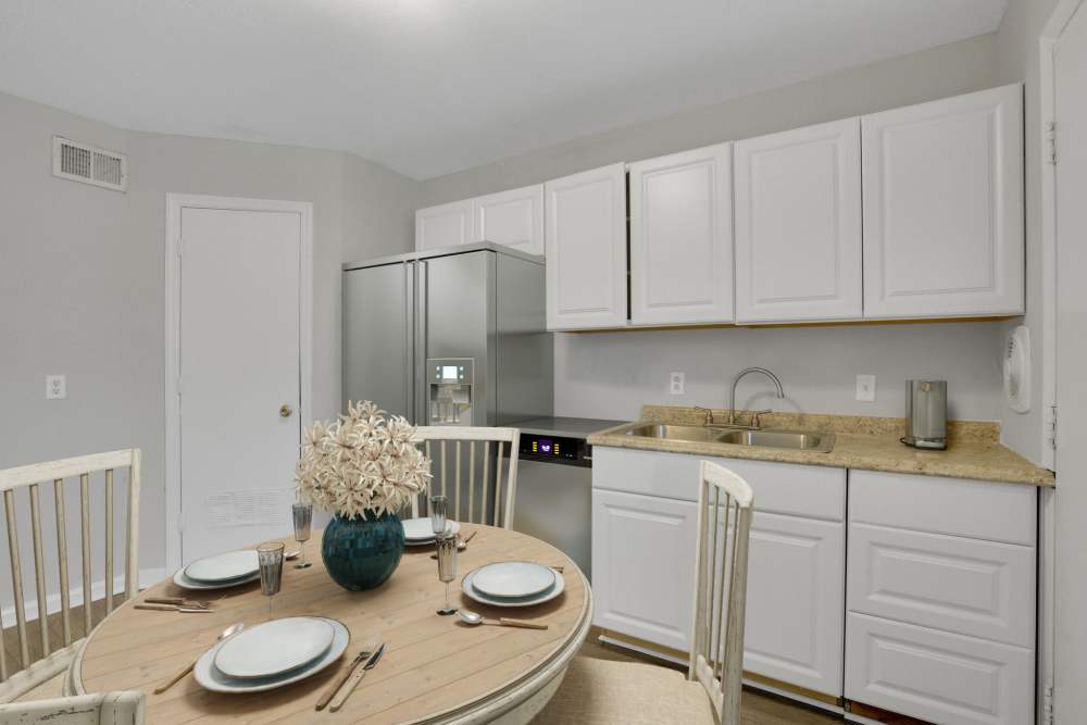 A model apartment dining room and kitchen at Garrett Woods Apartment Homes in Phenix City, Alabama