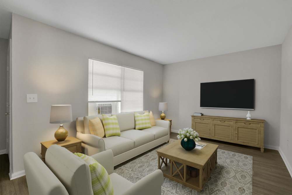 A furnished apartment living room with a window at Garrett Woods Apartment Homes in Phenix City, Alabama