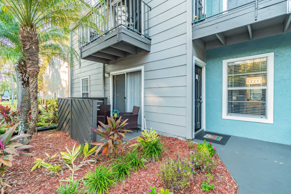 Exterior of apartment complex with private patio at Coopers Pond in Tampa, Florida