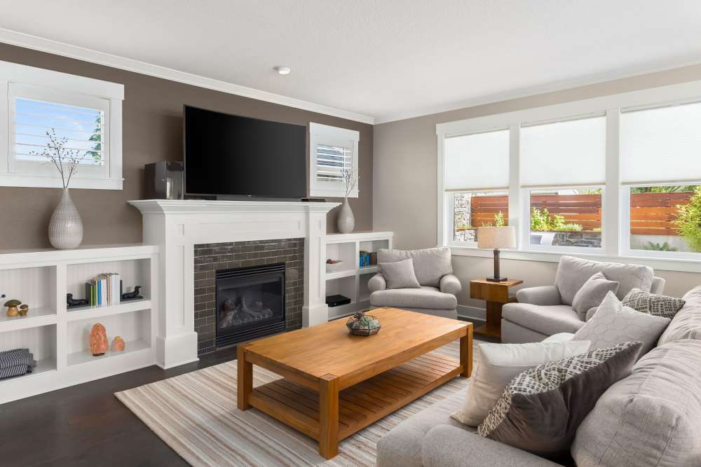 Apartment living room with large area rug, sectional, and television at The Avenue at 3060 in Atlanta, Georgia