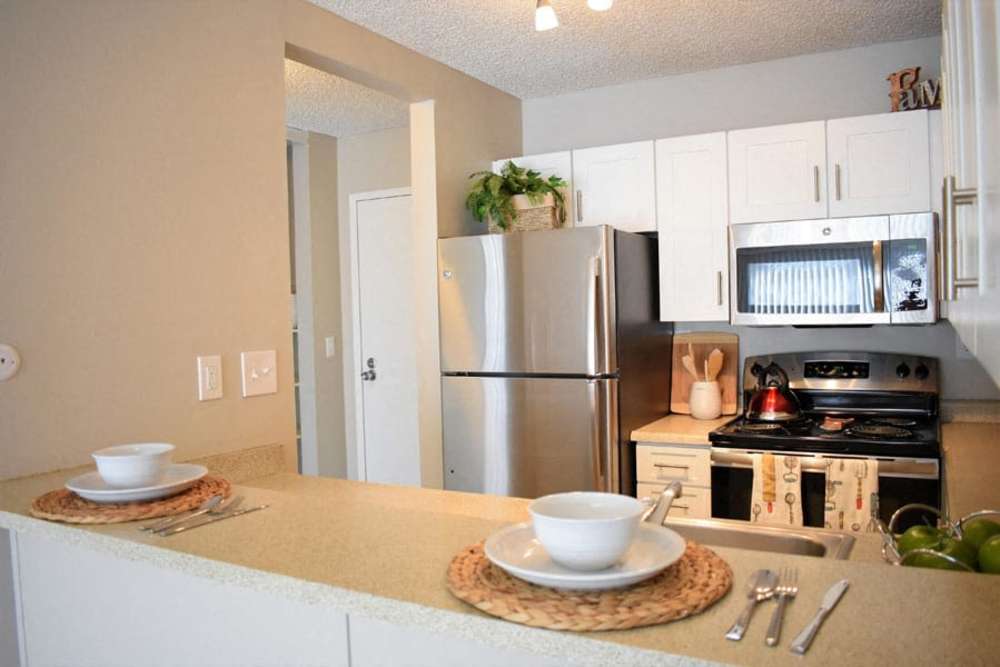 Kitchen with stainless-steel appliances and white cabinets at Parc Station in Santa Rosa, California