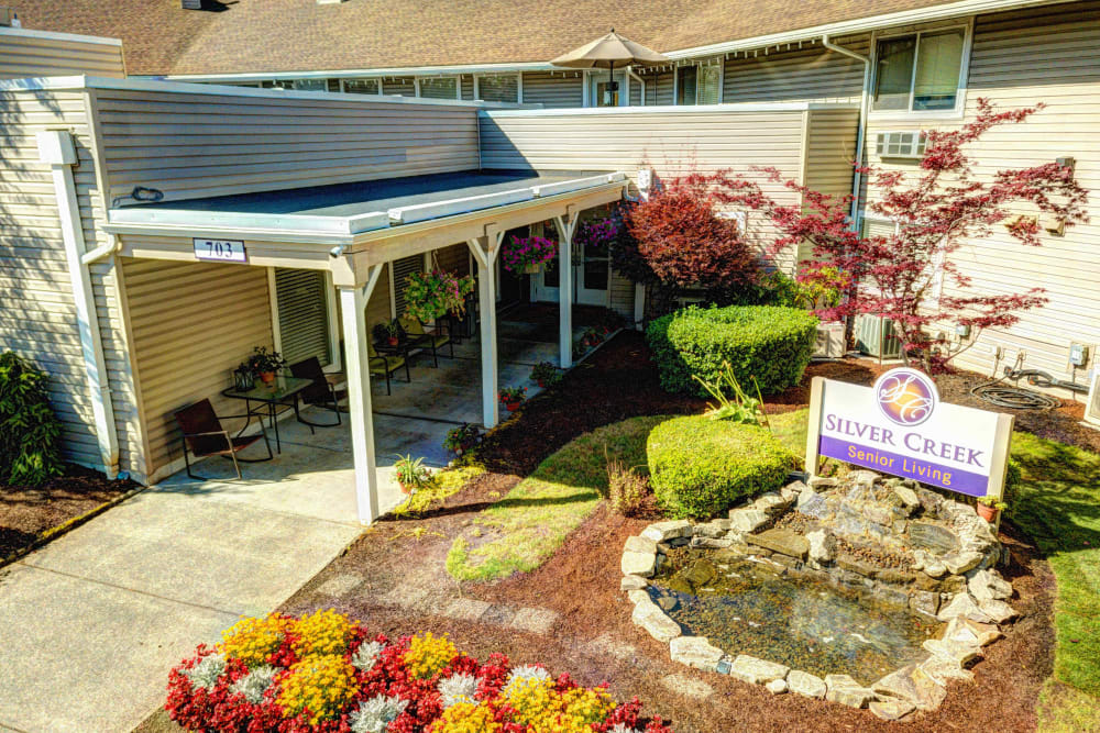 Aerial view of the beautifully landscaped main entrance at Silver Creek Senior Living in Woodburn, Oregon