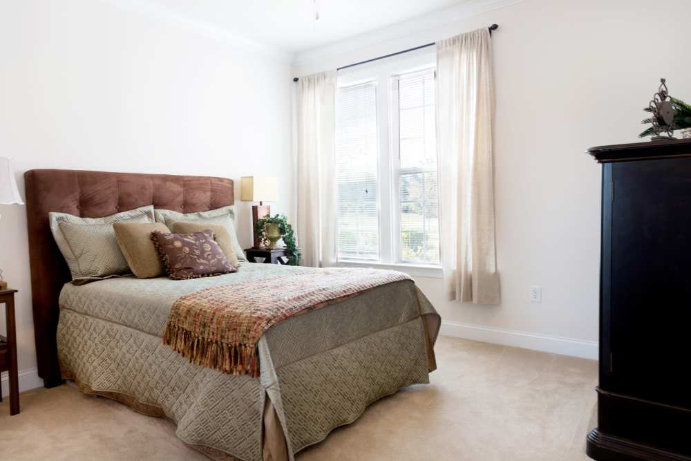 A queen-sized bed in a model apartment at Cloisters at Carolina Forest in Myrtle Beach, South Carolina