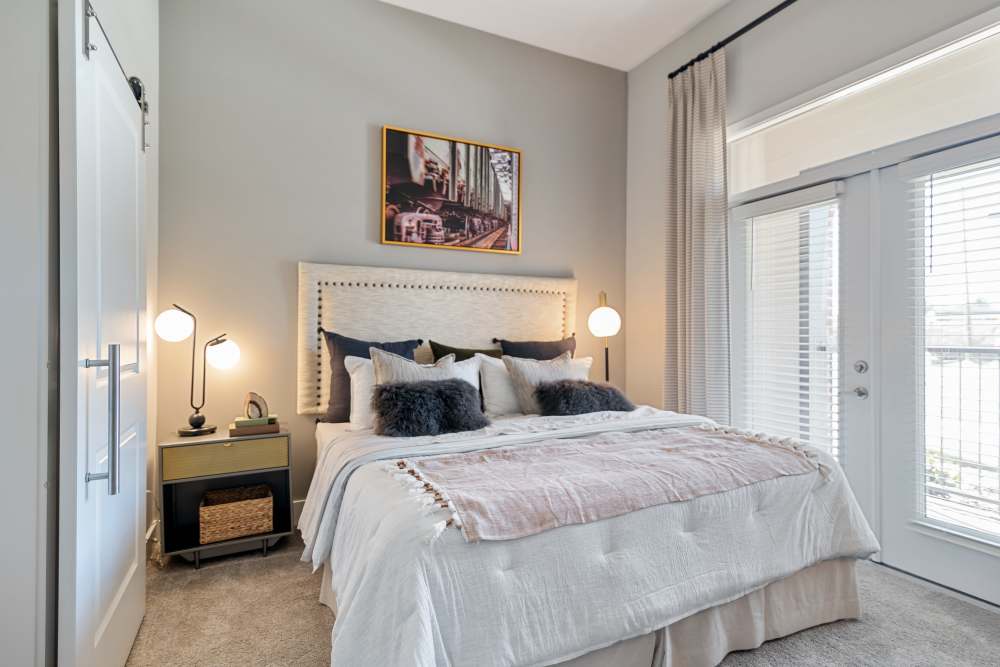 Apartment bedroom with bright windows at 101 Depot in Smyrna, Tennessee