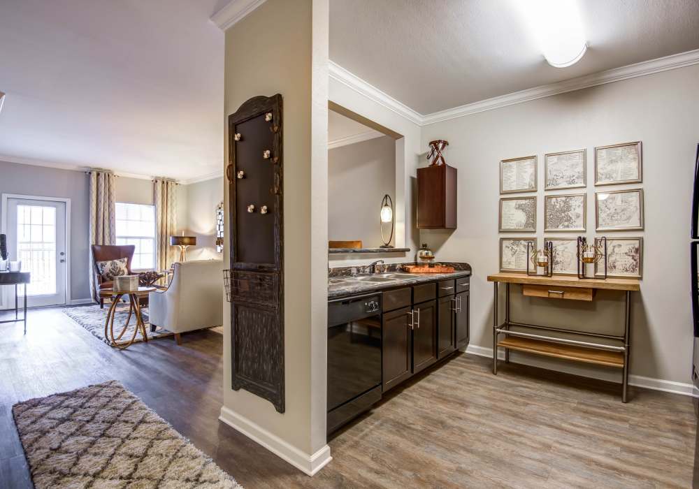 Kitchen with bar, refrigerator, stove, microwave opening to living and dining room hardwood floors at Maystone at Wakefield in Raleigh, North Carolina 