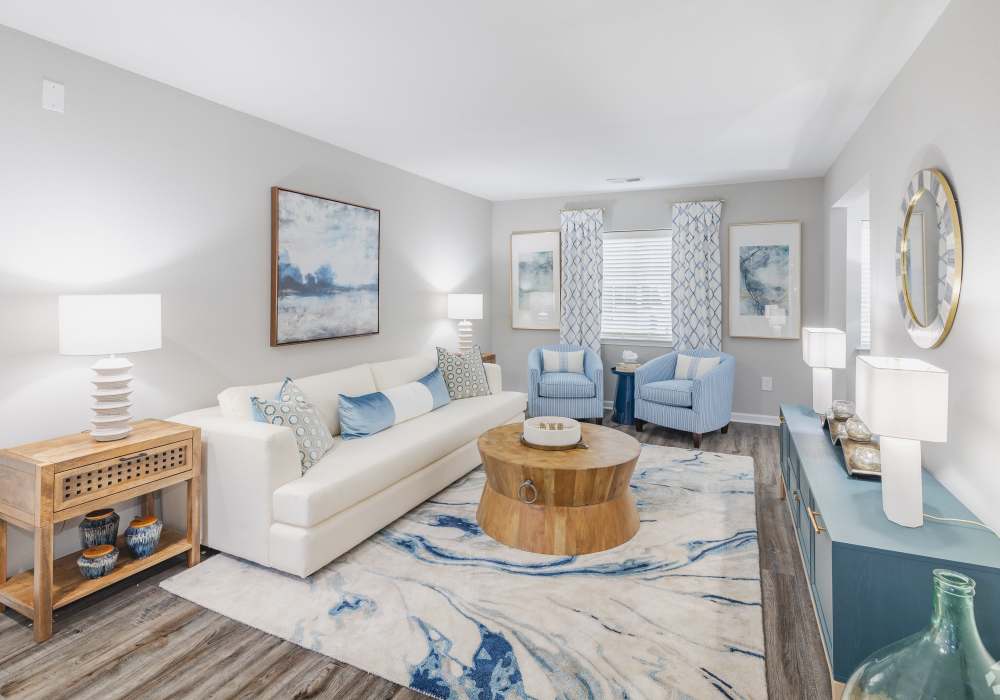 Well lit and open living room with hardwood flooring at River Landing in Myrtle Beach, South Carolina