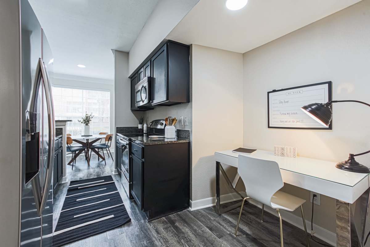 Kitchen with view to study table at The Village At Bellaire Apartments in Houston, Texas