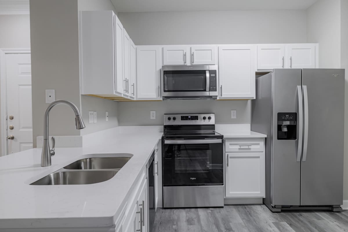Kitchen with hard wooden flooring at The Village At Bellaire Apartments in Houston, Texas