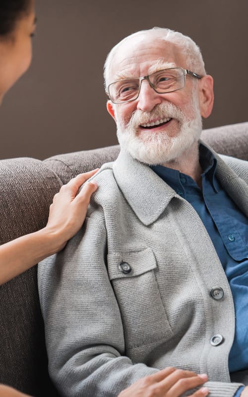 Resident sitting and talking with a nurse at Regency Redmond Rehabilitation and Nursing Center in Redmond, Oregon