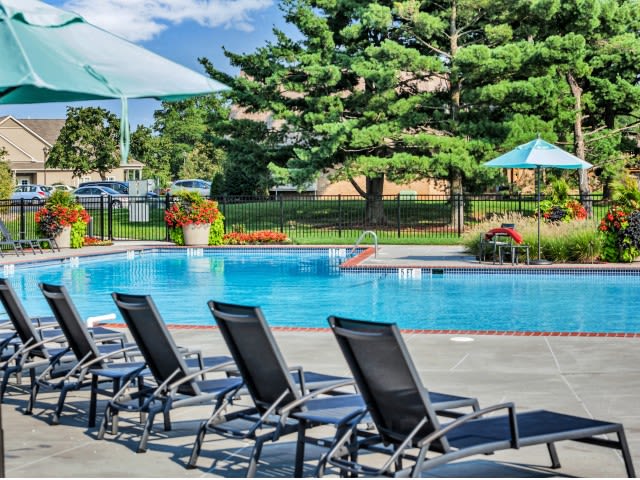 Sparkling pool with lounge chairs and umbrella at Franklin Commons, Bensalem, Pennsylvania