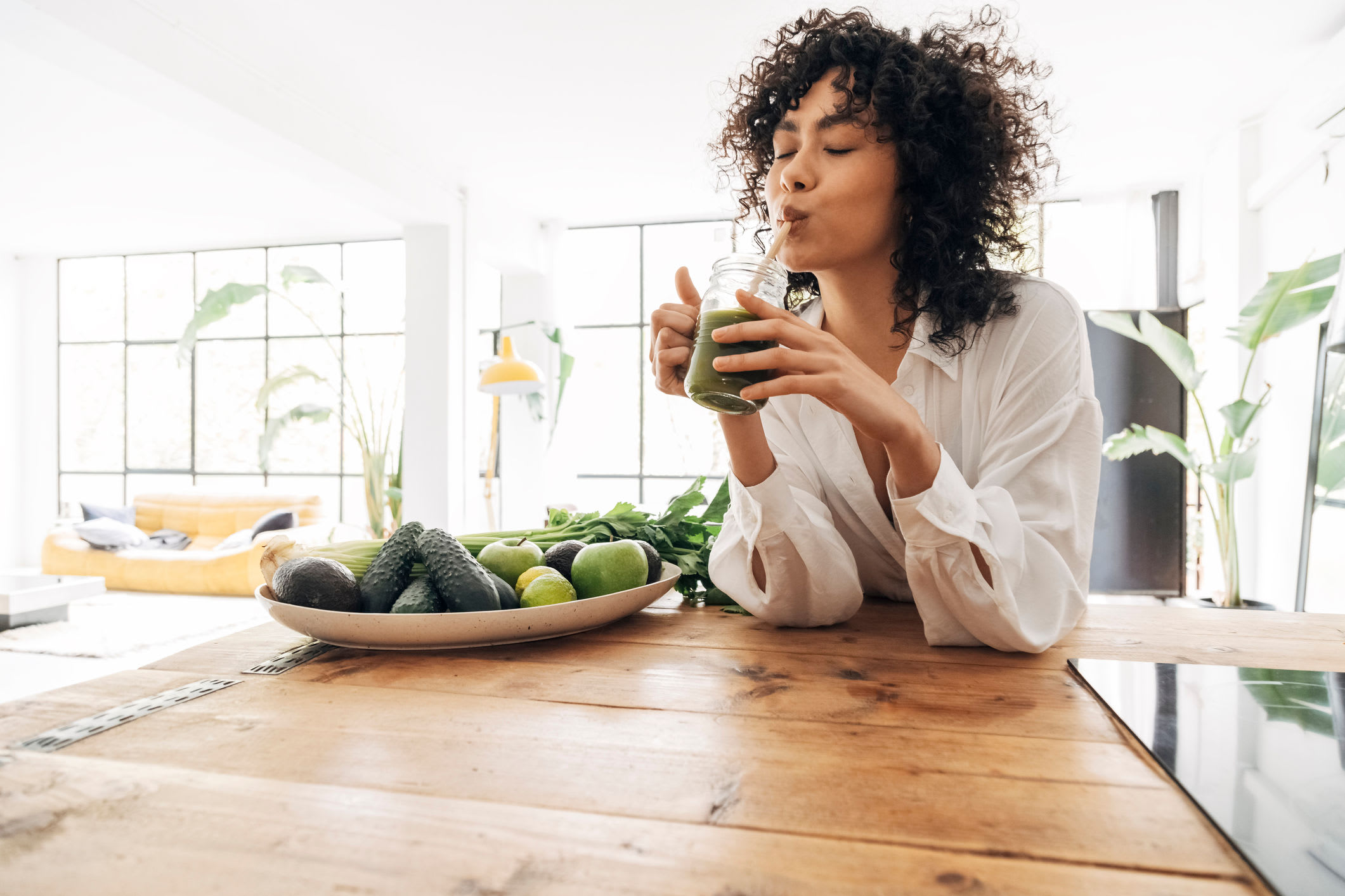 Resident drinking juice in at the table of her new dining room at Cheltenham Station in Philadelphia, Pennsylvania