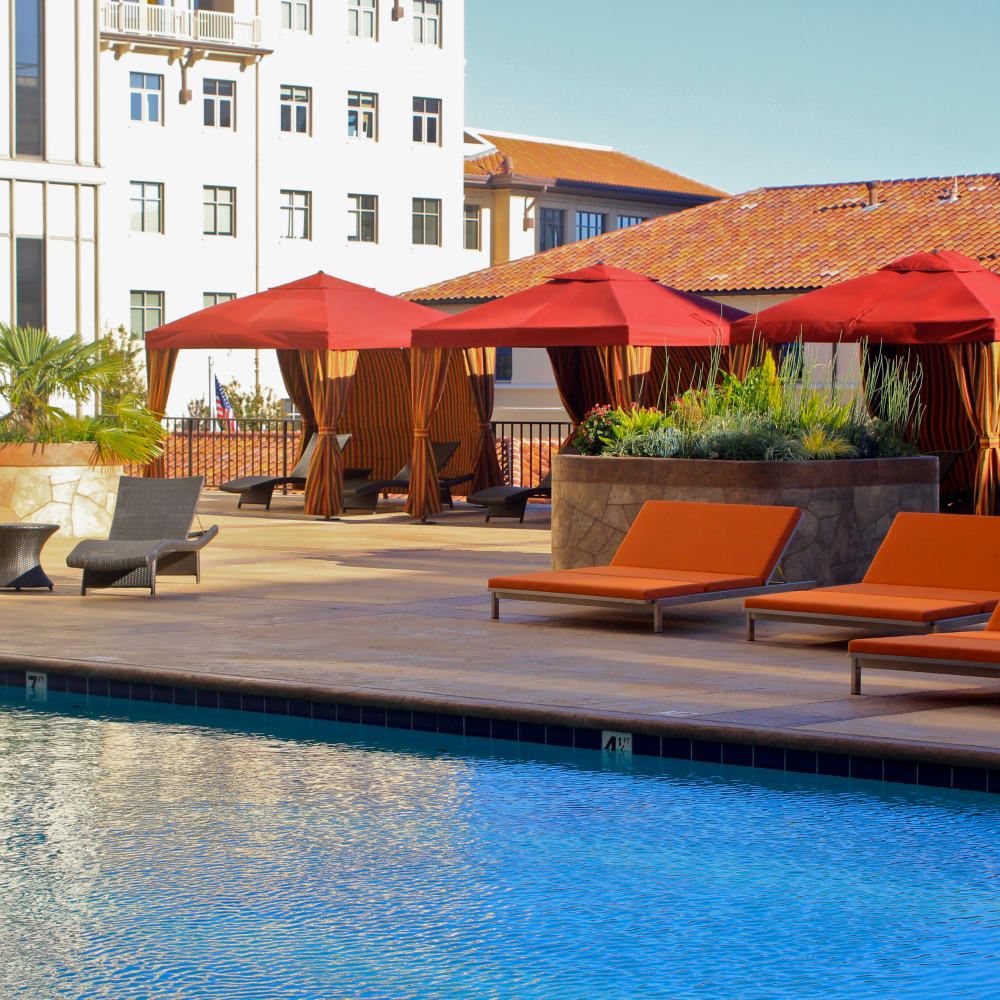 Pool with patio seating at Hillsborough Plaza Apartments in San Mateo, California