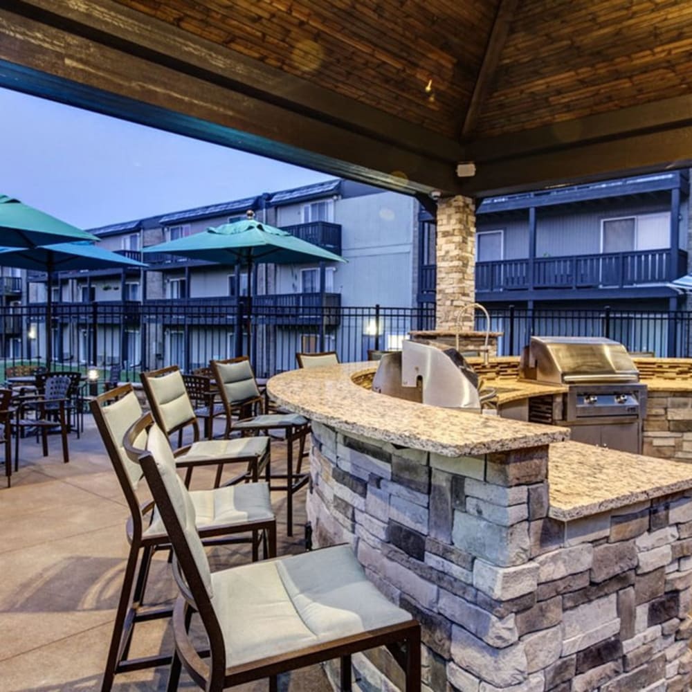 Outdoor seating area with grills at The Falls in Mission, Kansas