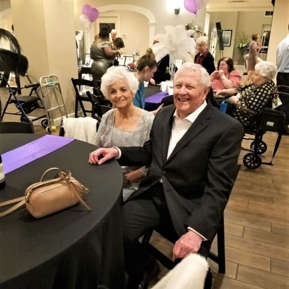 Residents sitting at a table for a nice event at Inspired Living Kenner in Kenner, Louisiana