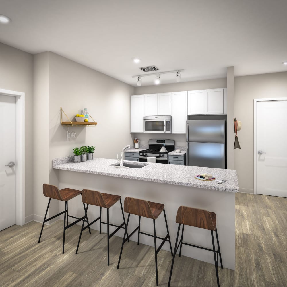 Kitchen with bar style seating at UNCOMMON Wilmington in Wilmington, North Carolina