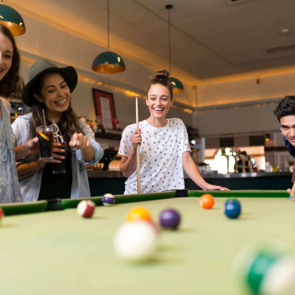 Residents playing billiards at LATITUDE at Kent in Kent, Ohio