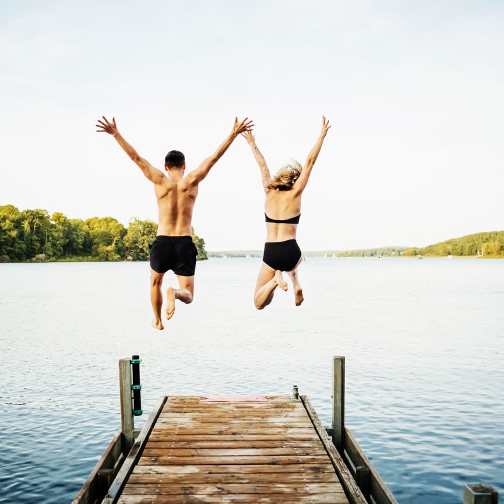 Couple running into a river together near LATITUDE at Kent in Kent, Ohio