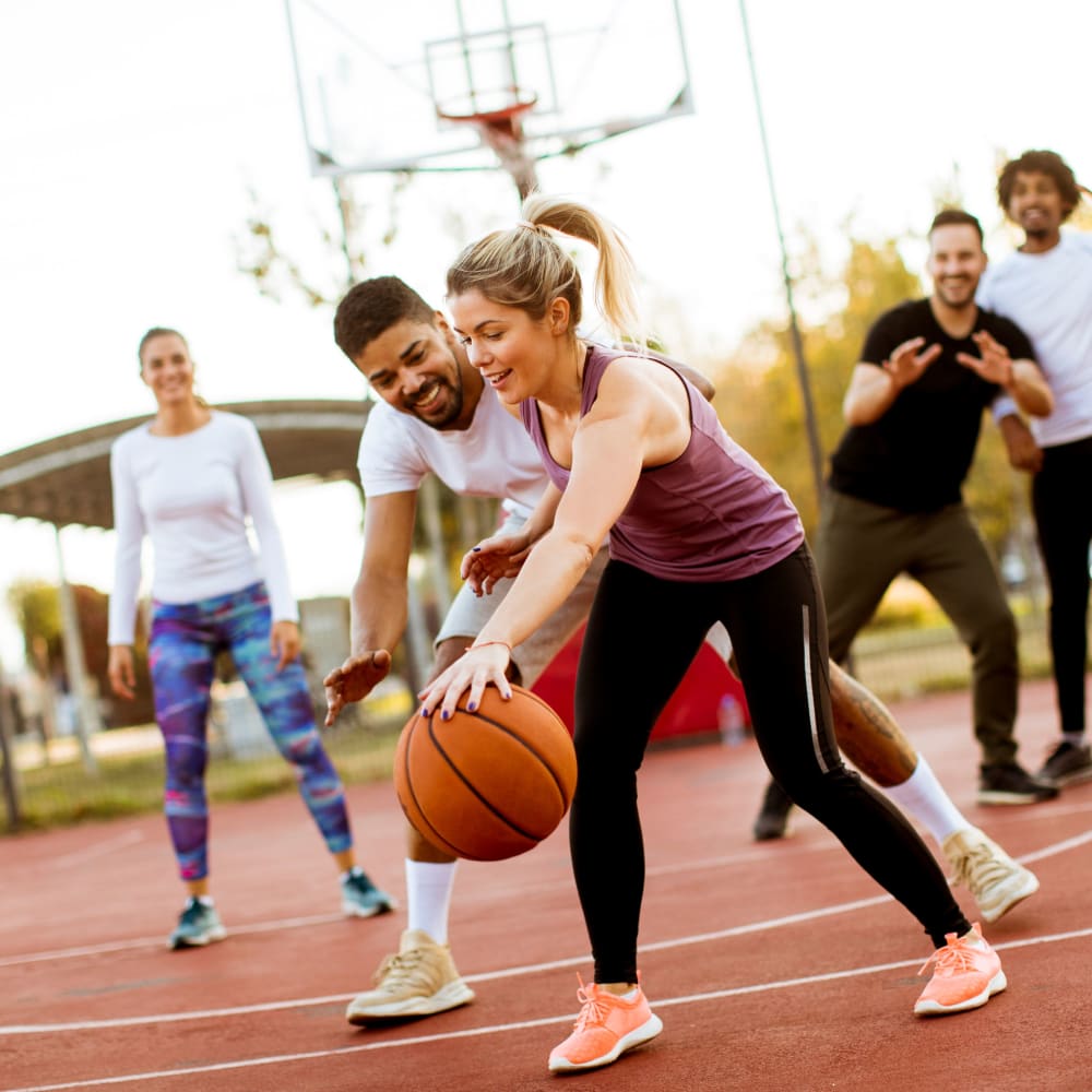 Friends playing basketball together in Lincoln, Nebraska near LATITUDE