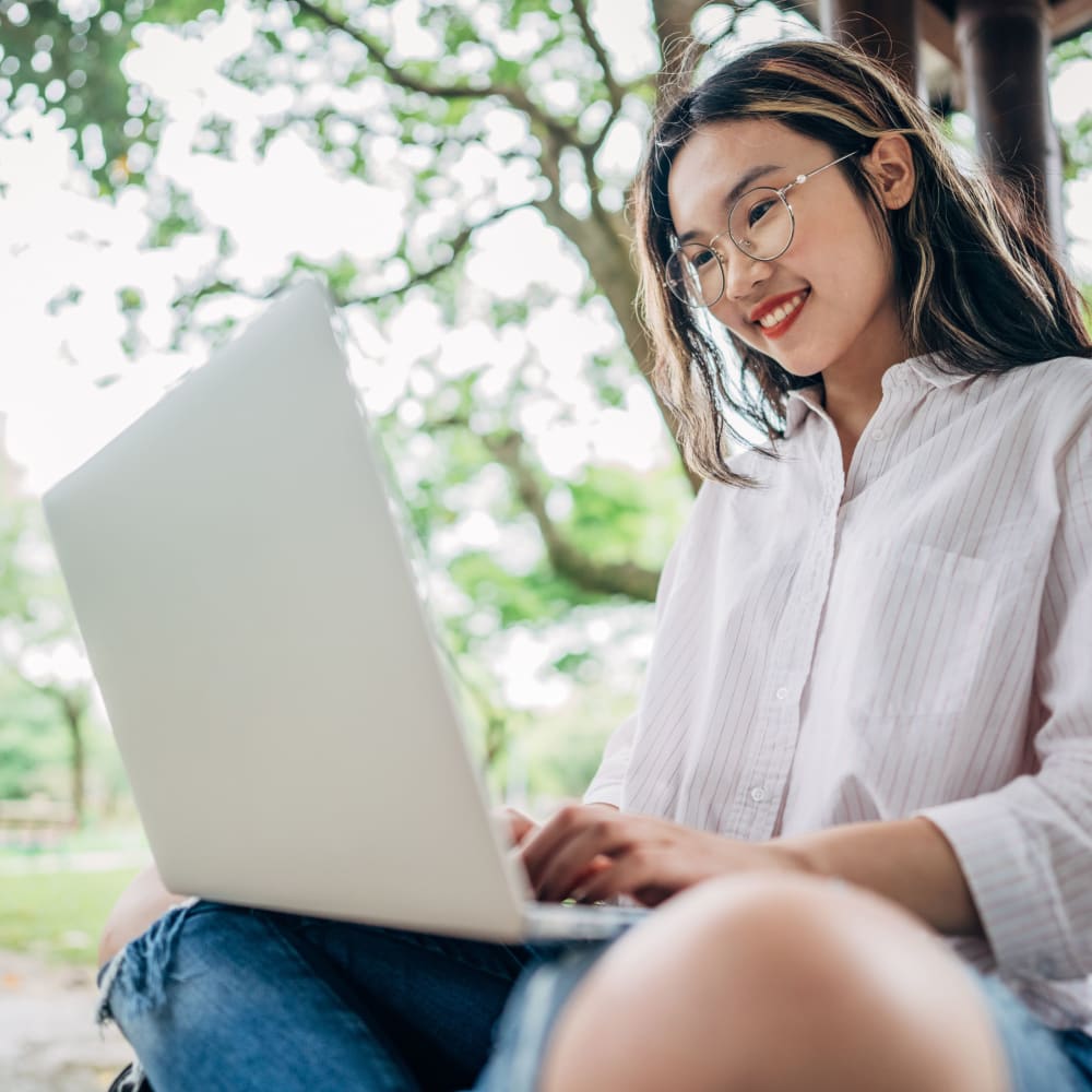 Resident working on her laptop outside of ICON in Isla Vista, California