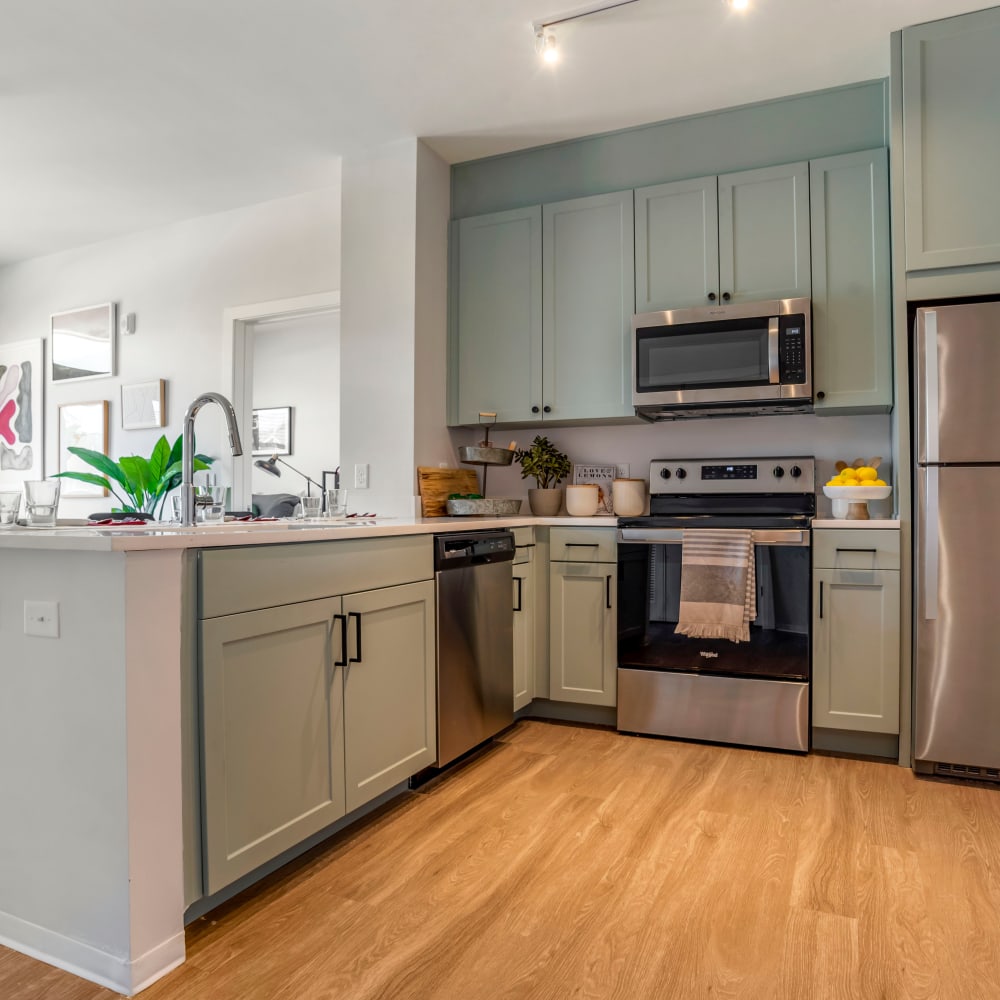 Kitchen with stainless steel appliances at UNCOMMON Tuscaloosa in Tuscaloosa Alabama