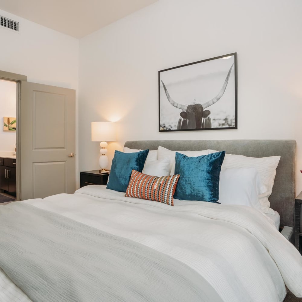 Well-furnished primary bedroom in a model home at Lakeshore Pearl in Austin, Texas