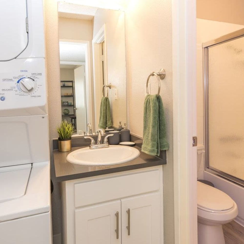 Bathroom with washer and dryer in model apartment home at The Davenport in Sacramento, California