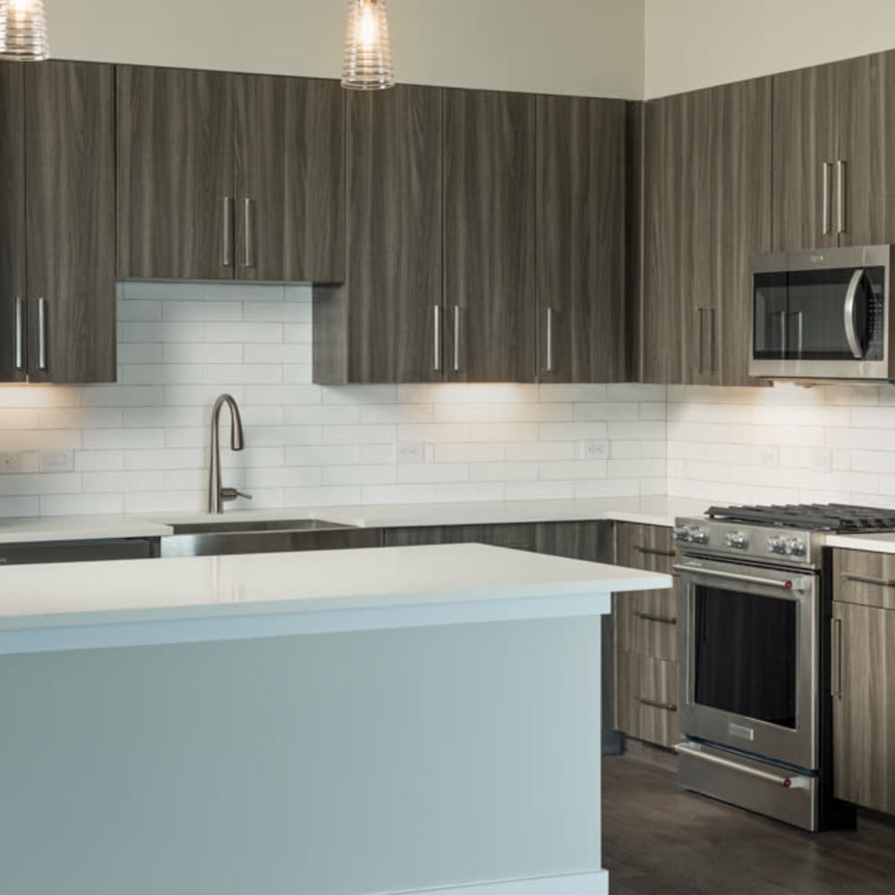 Gourmet kitchen with a subway tile backsplash and custom wood cabinetry in a model home at Magnolia Heights in San Antonio, Texas