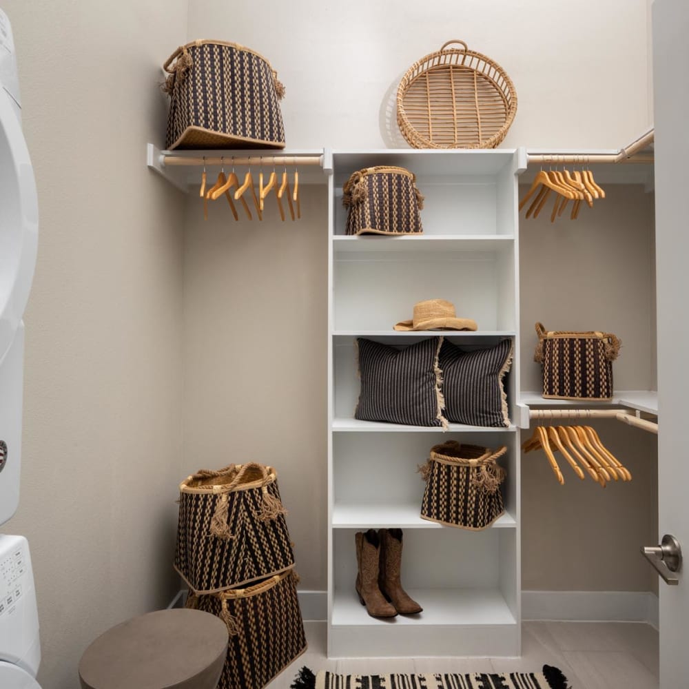 Spacious walk-in closet with built-in shelving in a model home at Magnolia Heights in San Antonio, Texas