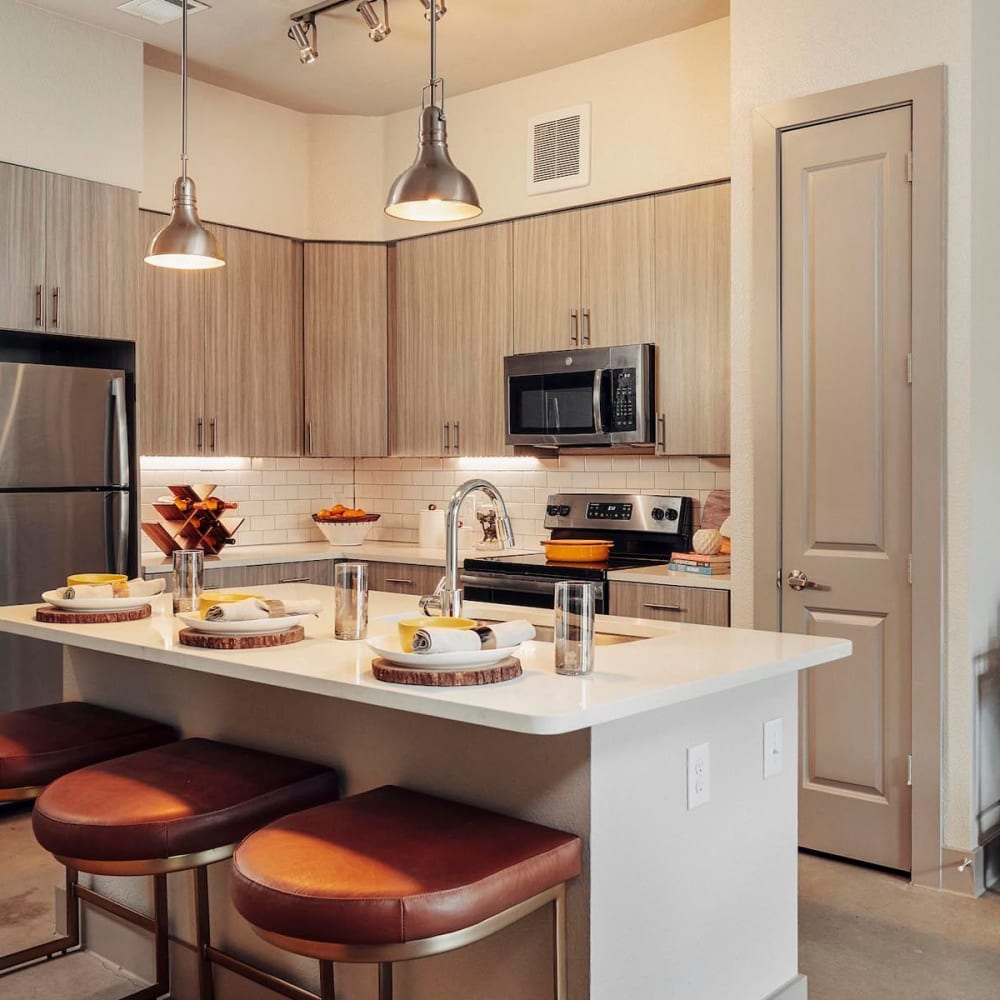 Bar seating at a model apartment's kitchen island at The Guthrie in Austin, Texas