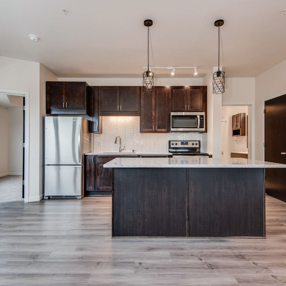 Kitchen with an island and granite counters at Oaks Minnehaha Longfellow in Minneapolis, Minnesota