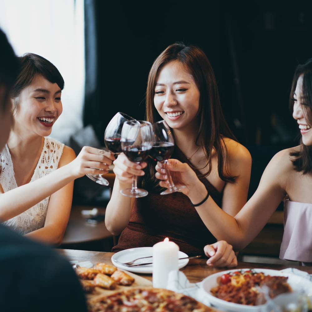 Friends chatting over food and wine at Oaks Minnehaha Longfellow in Minneapolis, Minnesota