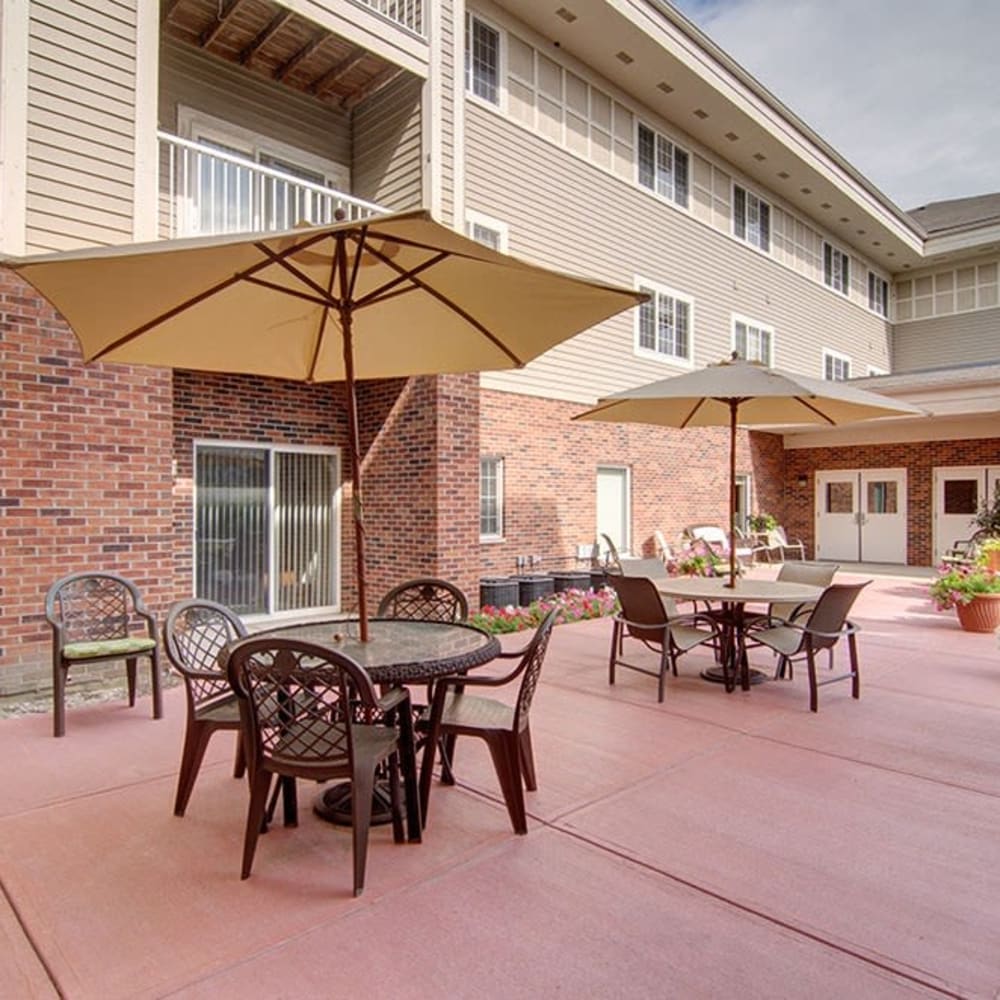 Modern outdoor seating with umbrellas and patio furniture at Randall Residence of McHenry in McHenry, Illinois