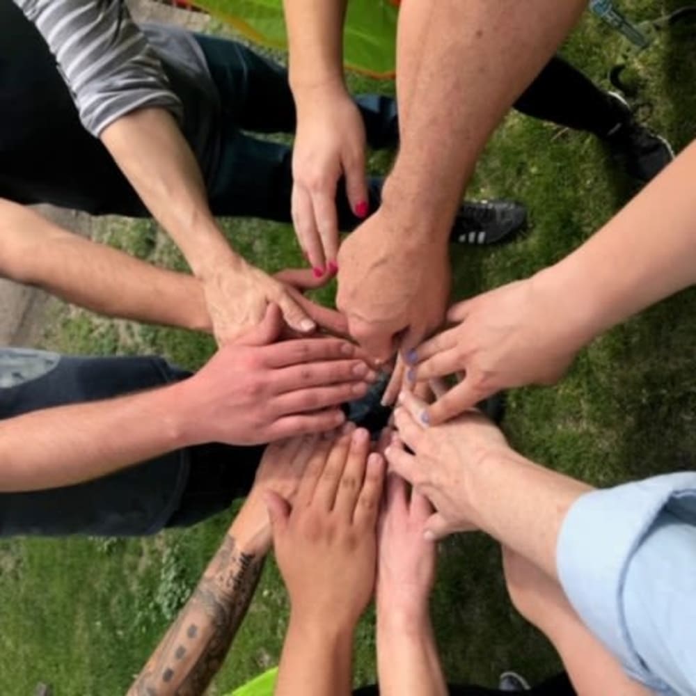 Mission Rockers' volunteering with Adopt-A-Spot: hands in for team work!