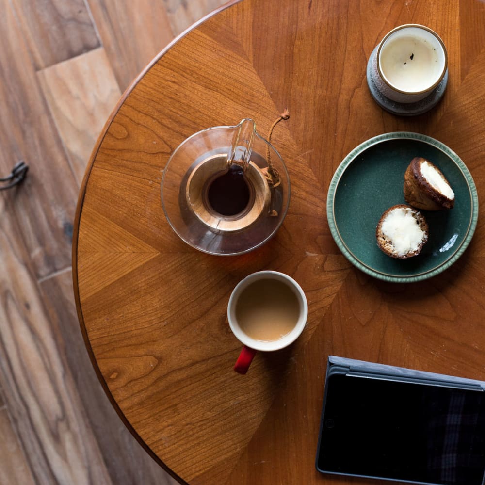 Coffee and a snack waiting on a table in a café near Oaks 5th Street Crossing at City Station in Garland, Texas