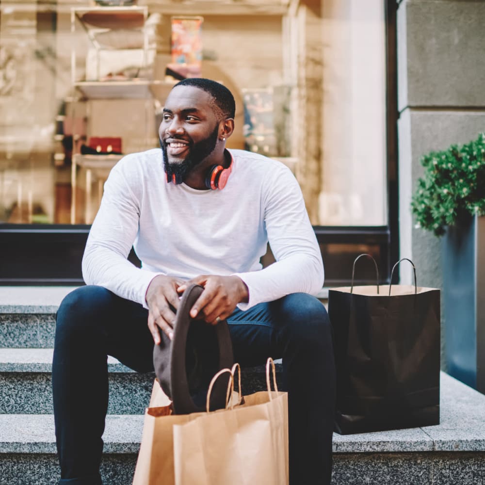 Resident taking a break from some retail shopping at the downtown stores near Oaks 5th Street Crossing at City Station in Garland, Texas