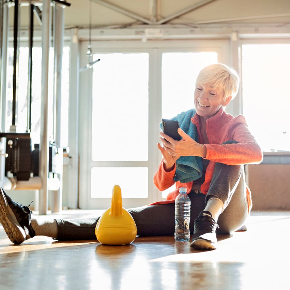 Resident taking a break from her workout in the fitness center at Oaks Braemar in Edina, Minnesota