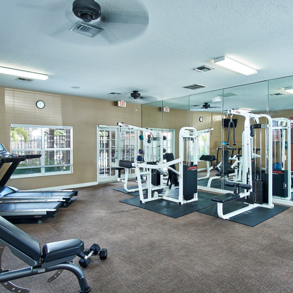 A fitness center with individual workout stations at Calais Park Apartments in St Petersburg, Florida