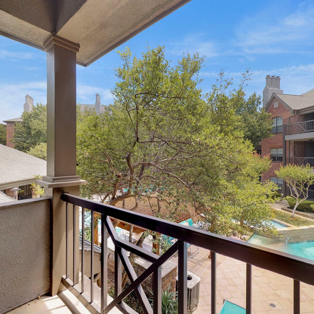 Private balcony outside an upper-floor model home at Oaks Hackberry Creek in Las Colinas, Texas