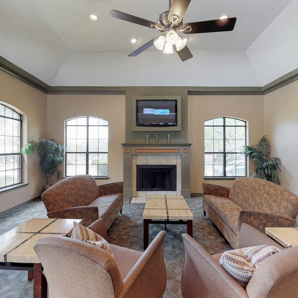 Lounge seating in front of the fireplace at Oaks Hackberry Creek in Las Colinas, Texas