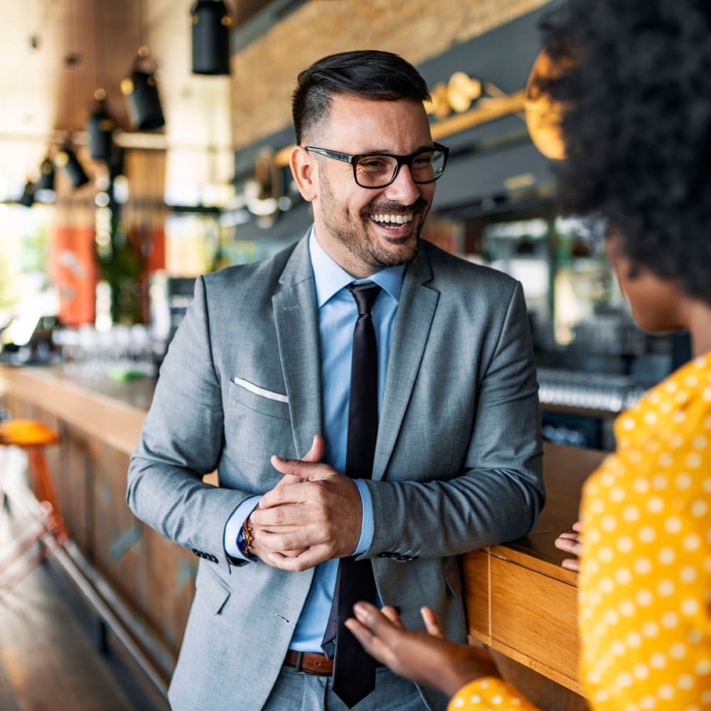 Resident meeting a colleague for coffee at a café near Oaks Hackberry Creek in Las Colinas, Texas