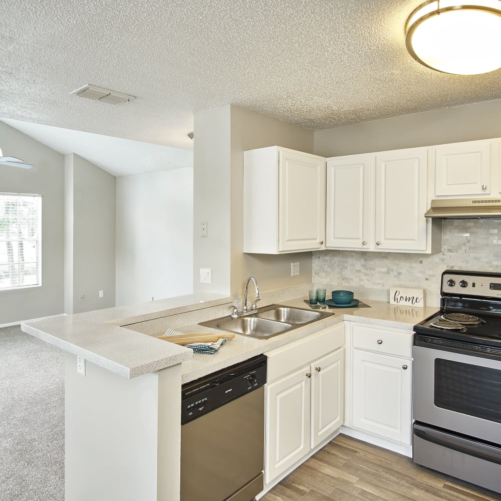 A kitchen with white cabinets at Avenue @Creekbridge in Brandon, Florida