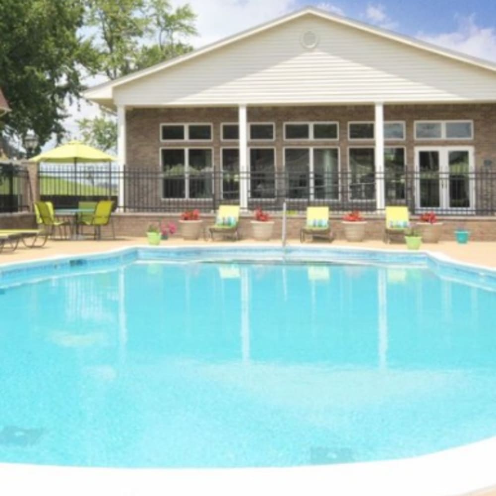 A swimming pool with a sundeck at Tanglewood Apartments in Louisville, Kentucky