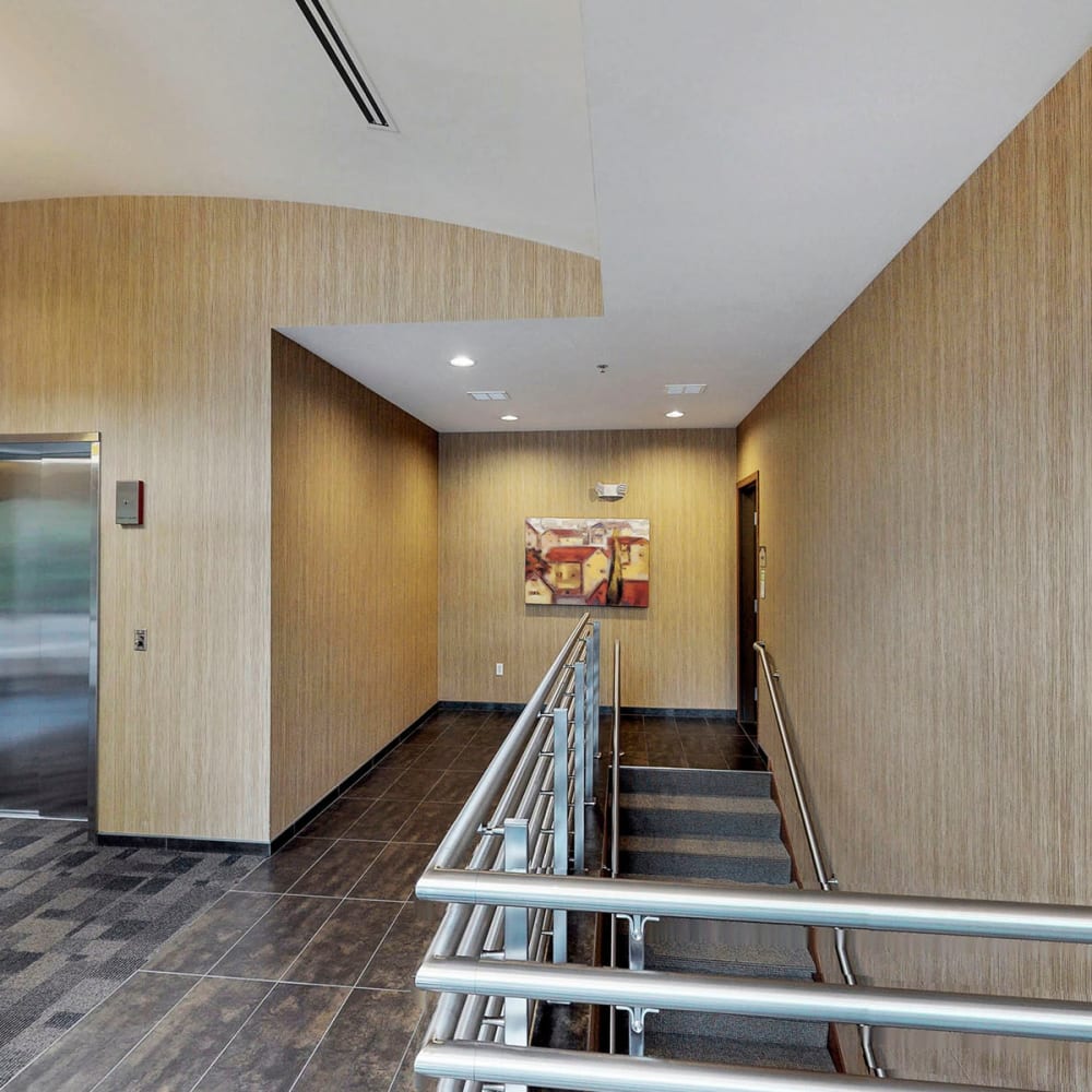 Stairway to the mezzanine from the ground floor at Oaks Glen Lake in Minnetonka, Minnesota