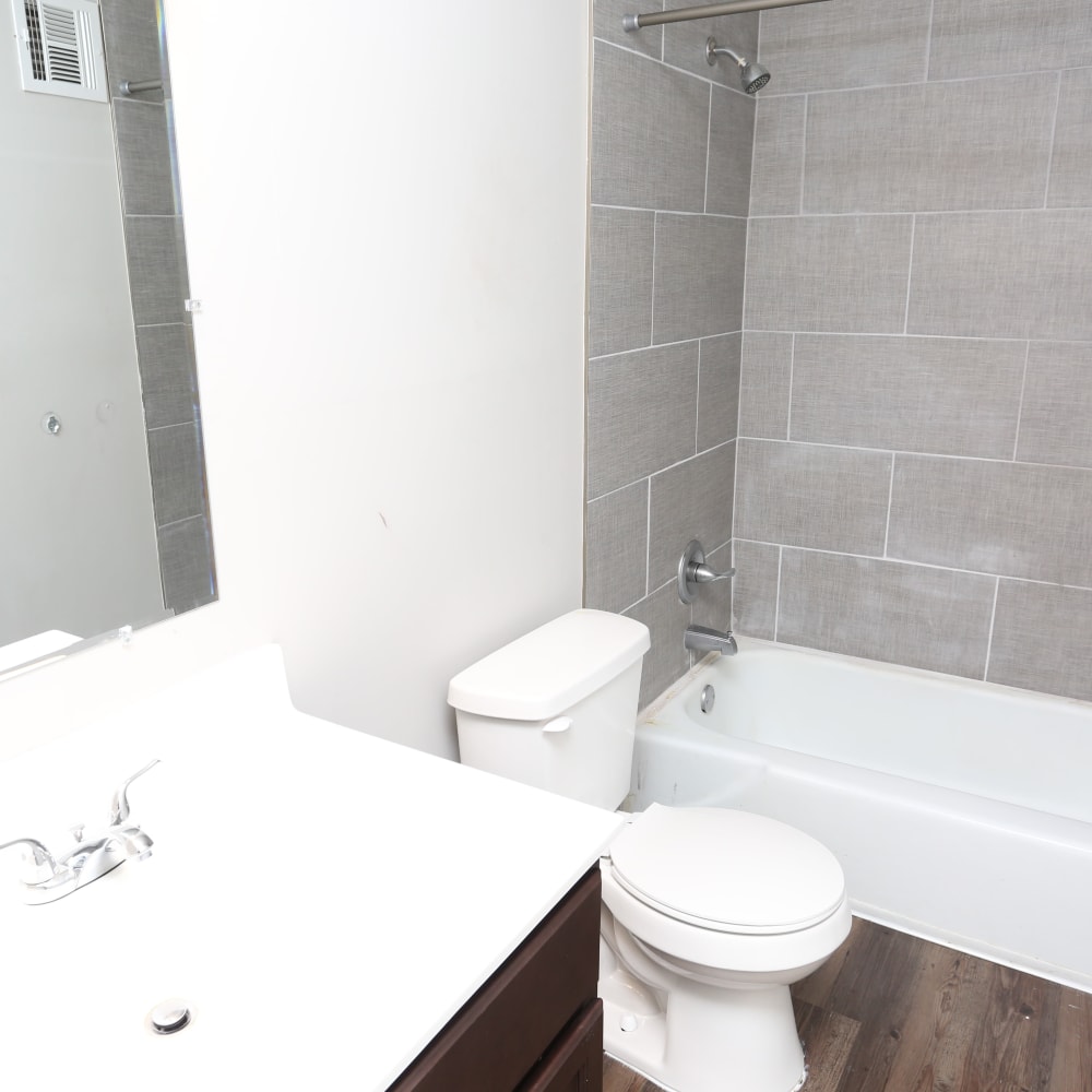 A bathroom with an oval tub and tiling at Reserve at Lindsay in Louisville, Kentucky
