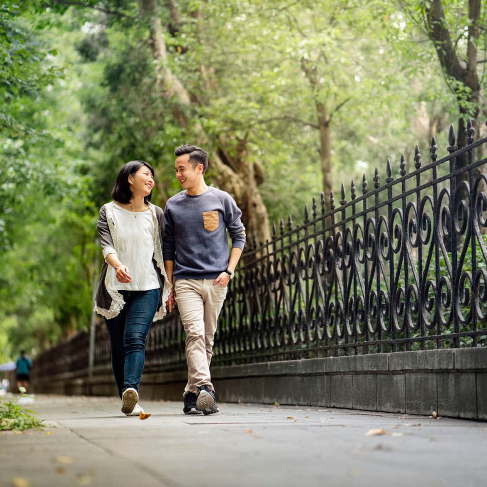 Resident couple going for a morning stroll through a park near Oaks Station Place in Minneapolis, Minnesota